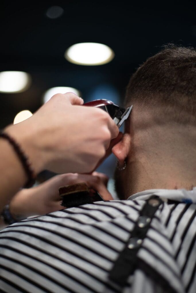 Man receiving a haircut and styling at hair systems Reno